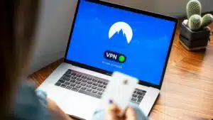 A person using a VPN on a laptop, symbolizing secure internet browsing in a modern indoor setting.