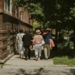 A diverse group of women walking together on a sunny day in a Chicago neighborhood street.