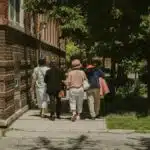 A diverse group of women walking together on a sunny day in a Chicago neighborhood street.