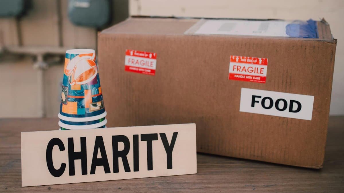 Image of a charity donation box filled with food supplies and paper cups.