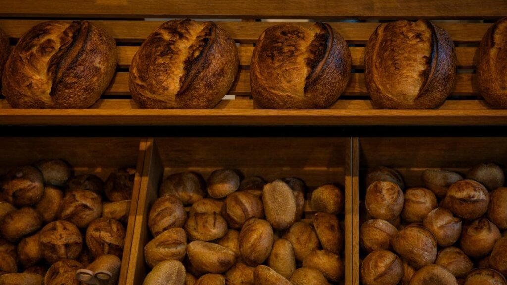 Rich selection of freshly baked artisan bread in a Berlin bakery shop.