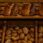 Rich selection of freshly baked artisan bread in a Berlin bakery shop.