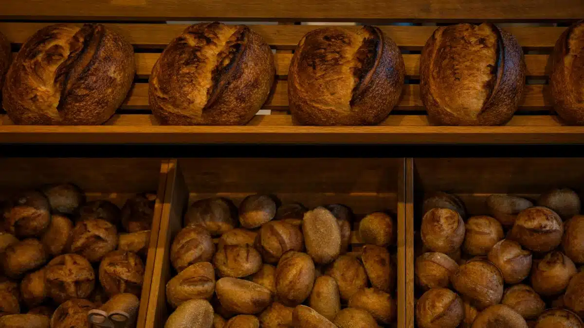 Rich selection of freshly baked artisan bread in a Berlin bakery shop.