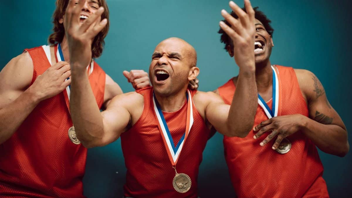 Three athletes celebrate their victory, showcasing joy and medals.