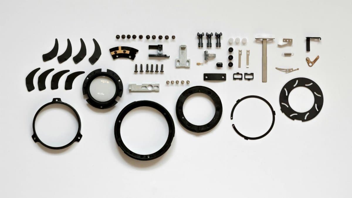 Organized layout of mechanical parts on a white surface, ideal for tech and engineering themes.