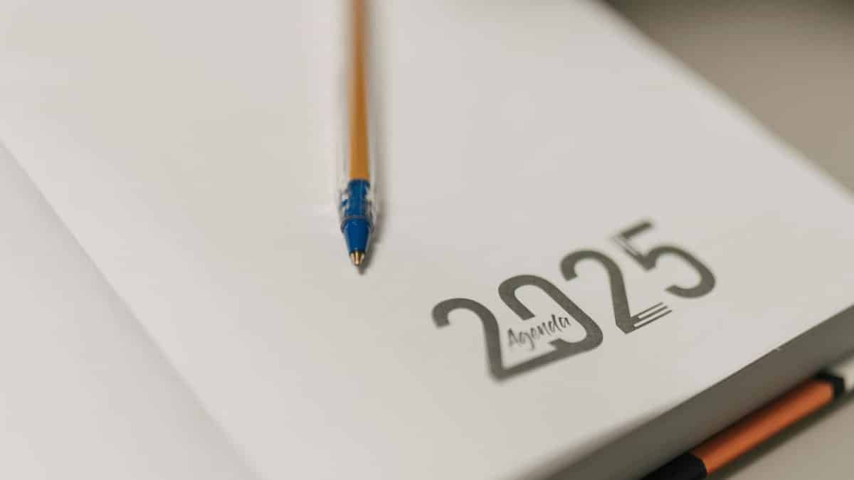 Closeup of a 2025 planner with a pencil, symbolizing planning and organization.