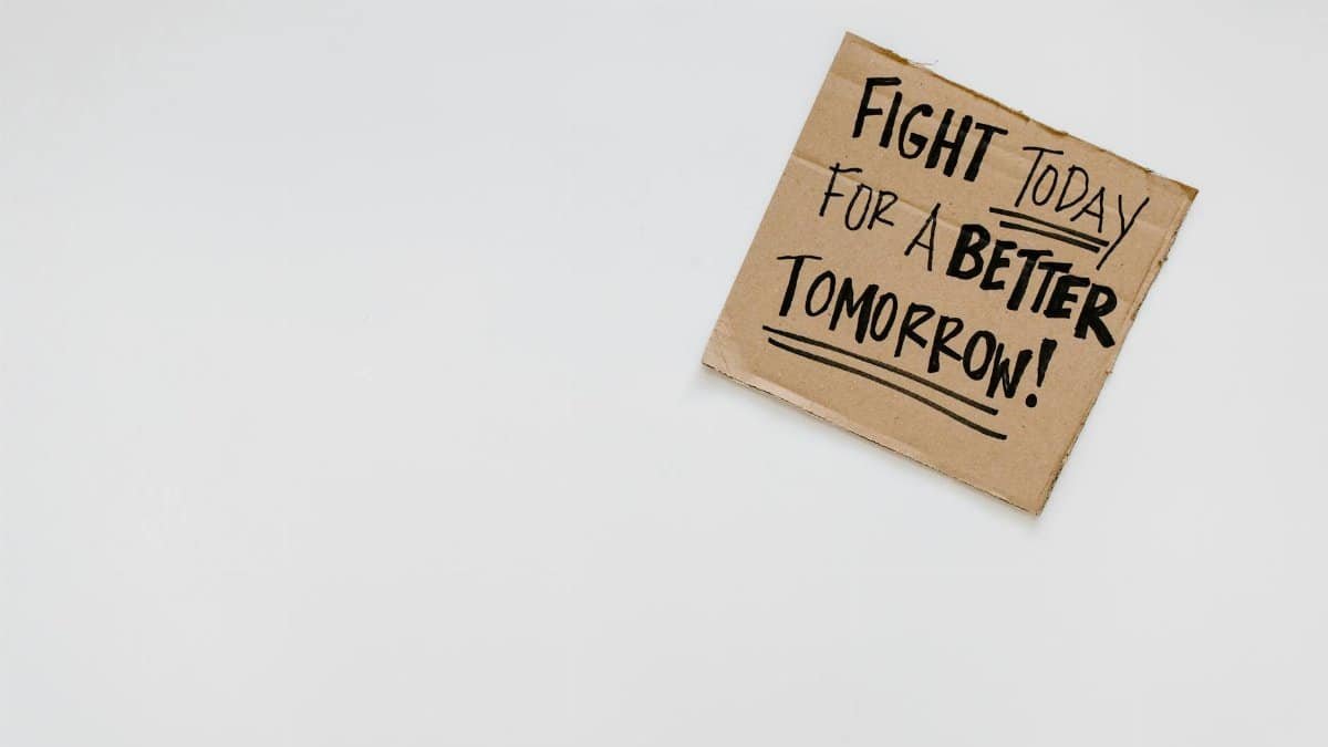 Handwritten motivational message on cardboard for a better future.