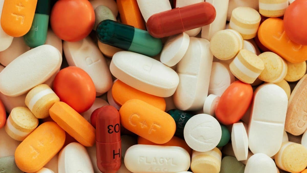 Close-up of assorted colorful pills and tablets on a surface.