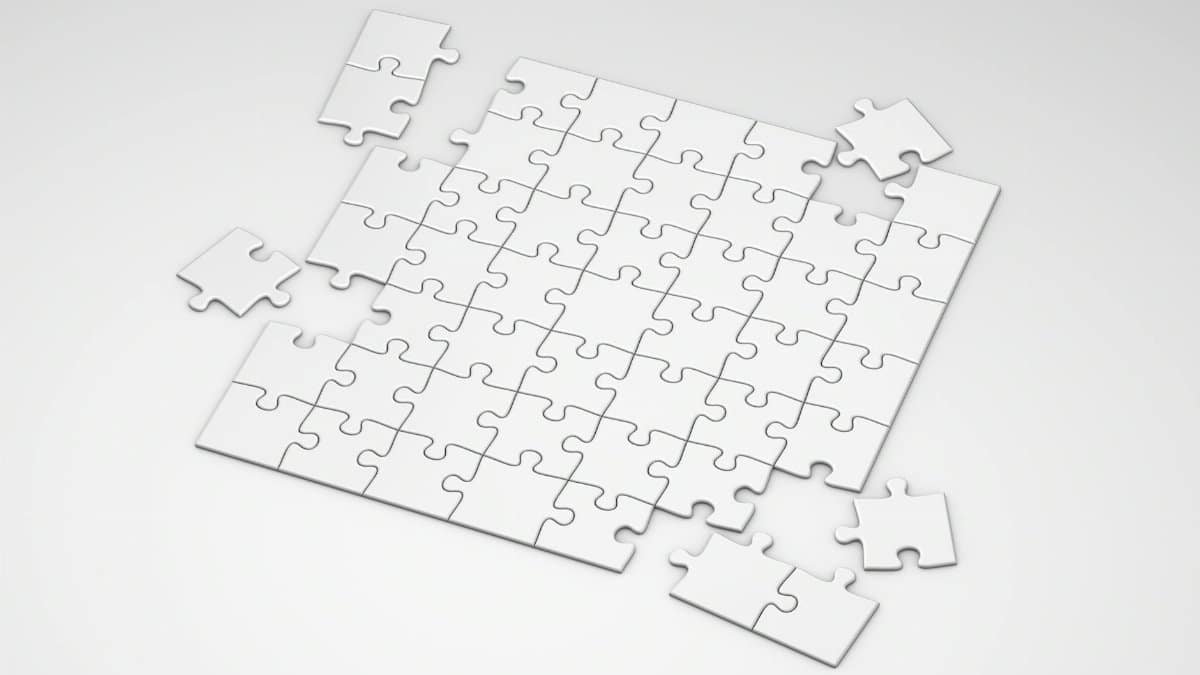 A top view of incomplete white puzzle pieces on a clean, minimalist background.