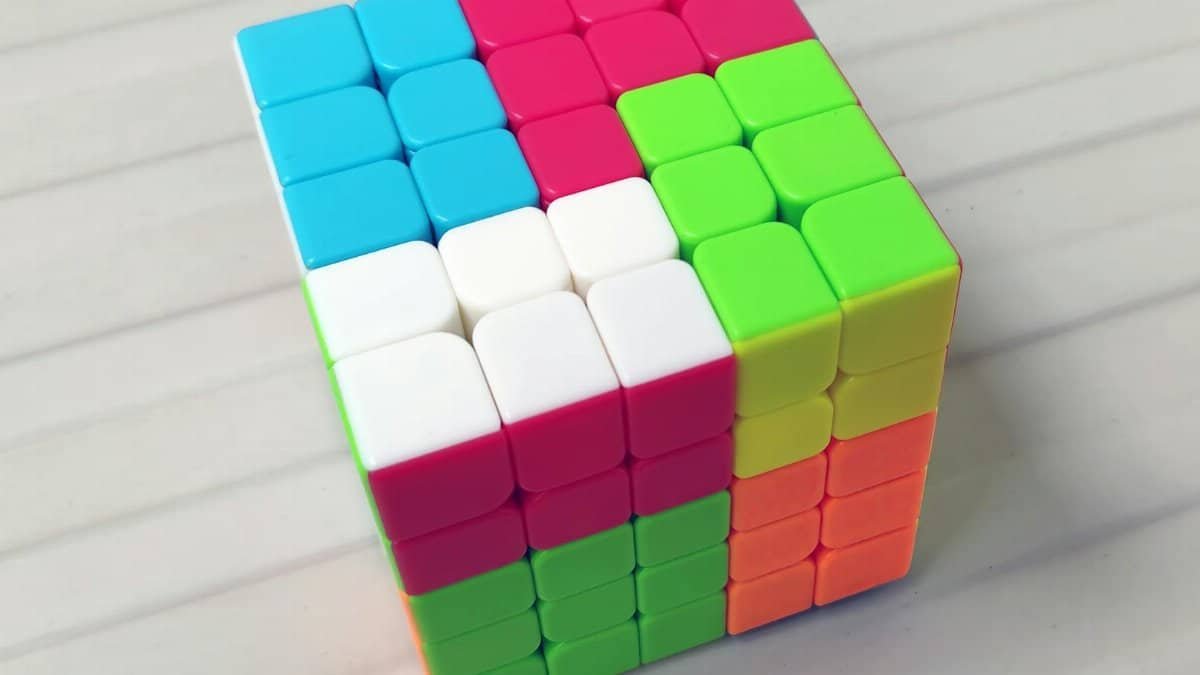 A vibrant Rubik's Cube with mixed colors on a white surface, showcasing complexity and puzzle-solving.