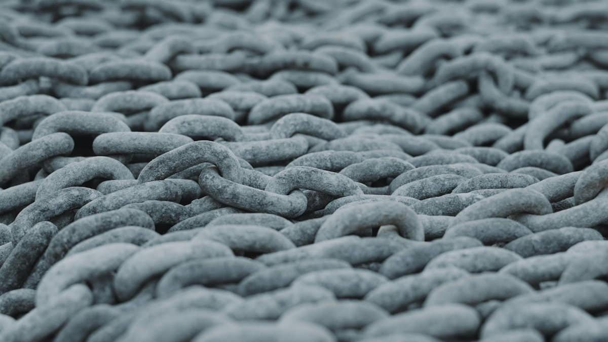 Detailed view of intertwined steel chains creating a rugged texture.