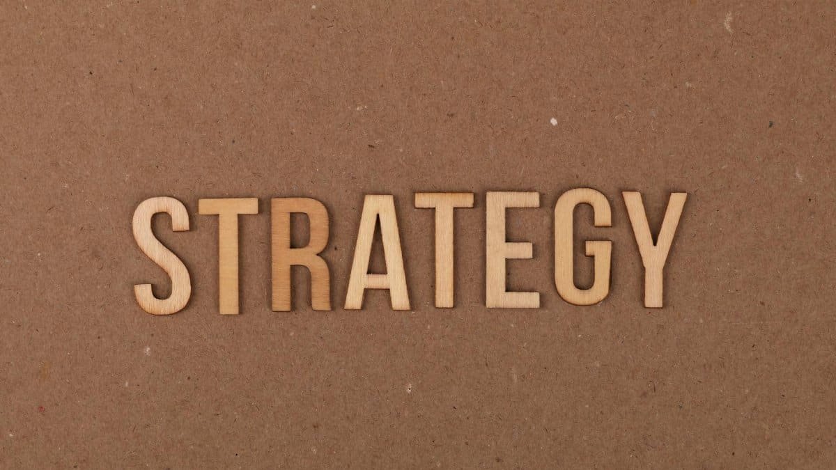 Wooden letters spelling 'Strategy' on a cardboard background, perfect for business concepts.