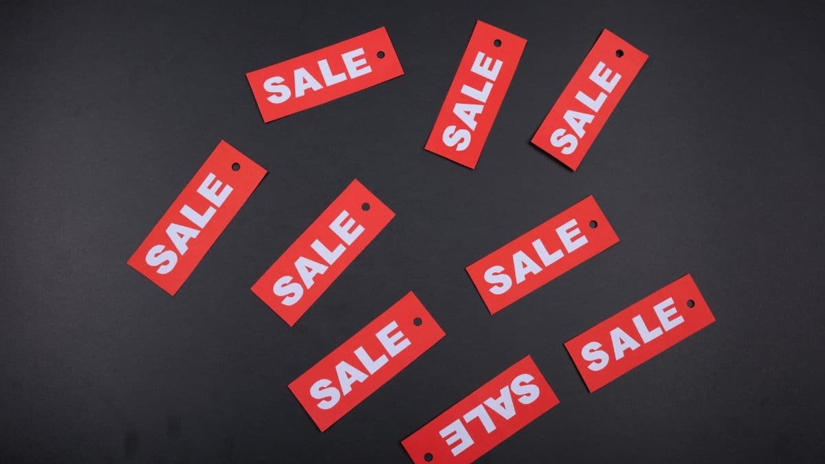 Red sale tags arranged on a dark background, ideal for retail promotions.