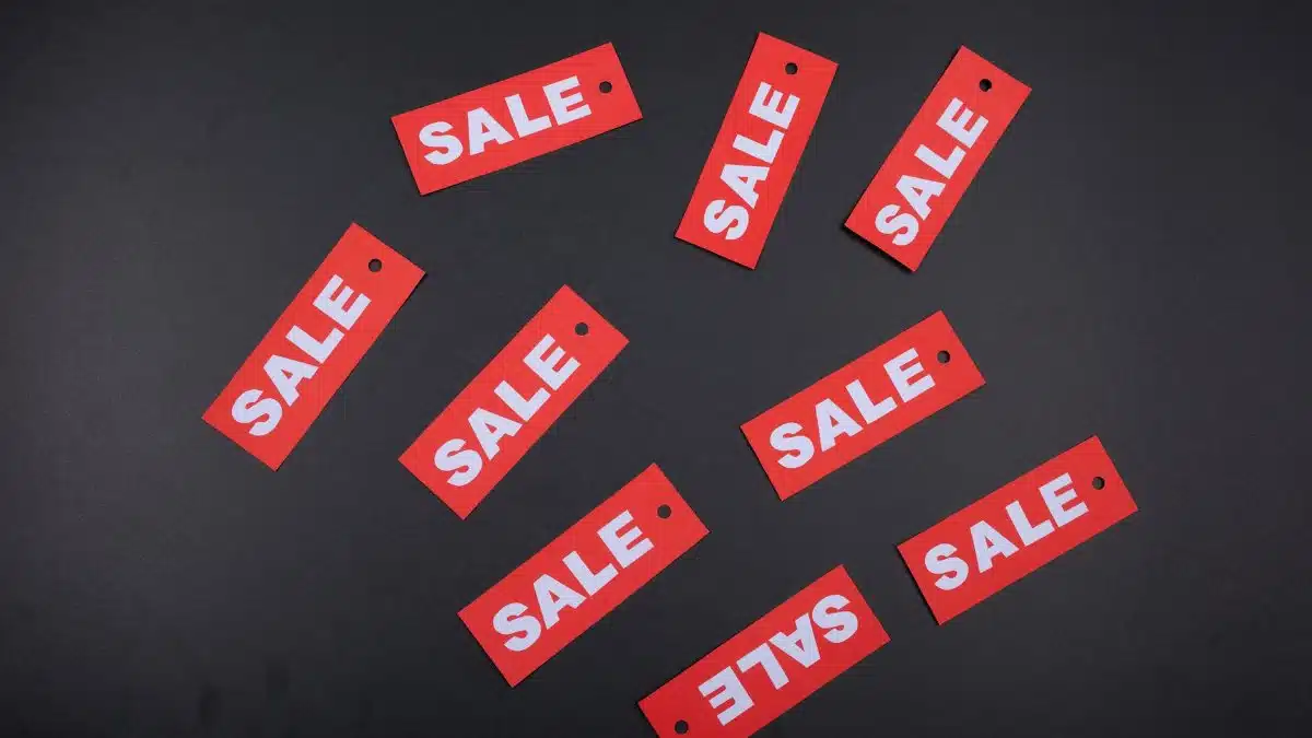Red sale tags arranged on a dark background, ideal for retail promotions.