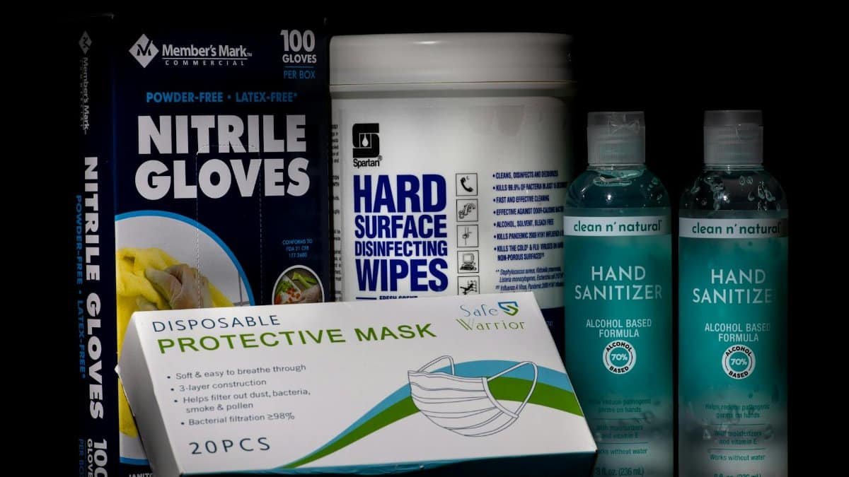 Front view of essential COVID-19 safety supplies including gloves, masks, wipes, and sanitizers.