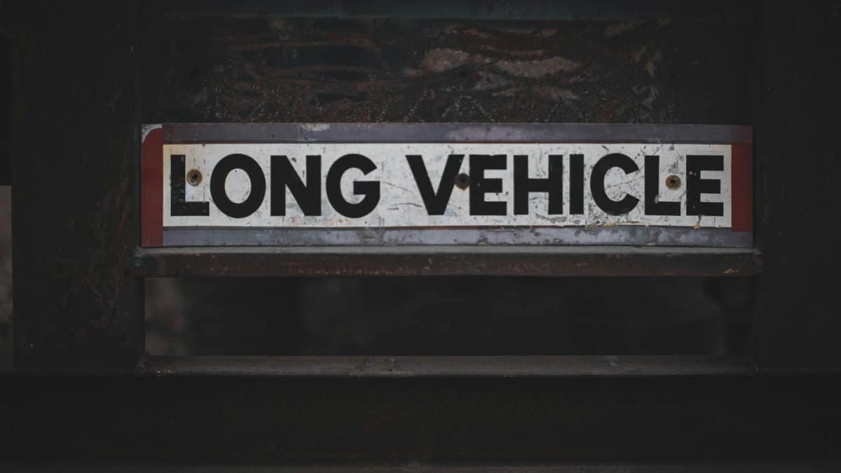 Detailed close-up of a 'Long Vehicle' sign on a metal structure, showcasing industrial signage.