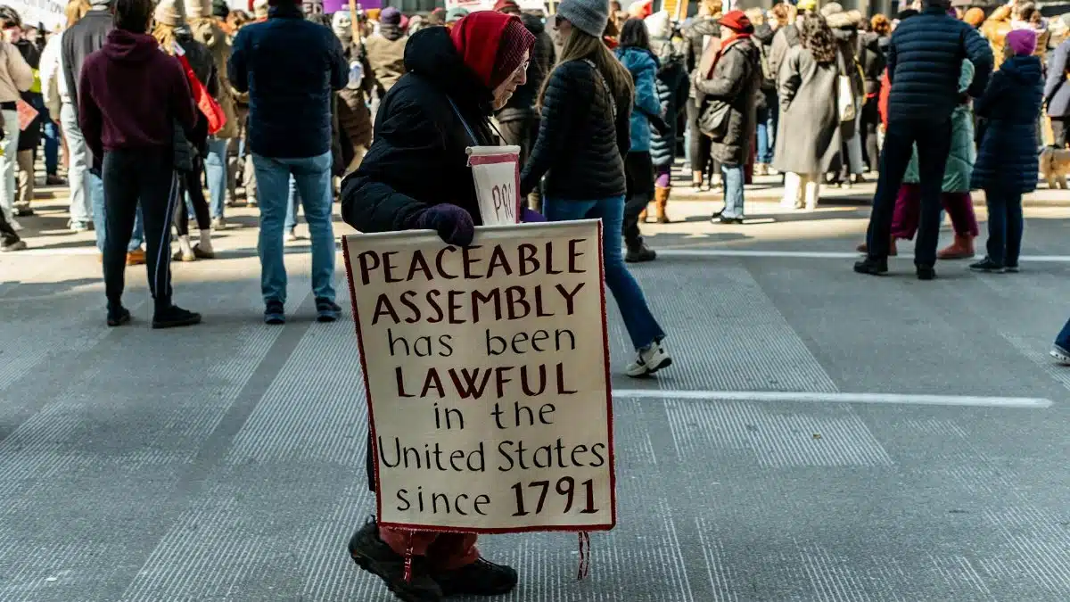 A demonstration advocating peaceable assembly rights in a city street.