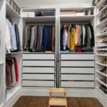 A neatly arranged walk-in closet showcasing a colorful variety of clothes and shoes.