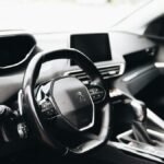 Sleek interior view of a modern car showing steering wheel and dashboard.