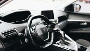 Sleek interior view of a modern car showing steering wheel and dashboard.