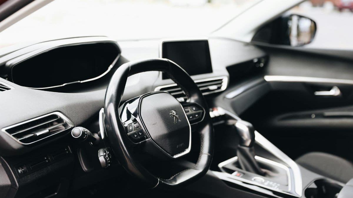 Sleek interior view of a modern car showing steering wheel and dashboard.