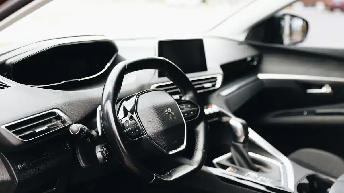 Sleek interior view of a modern car showing steering wheel and dashboard.