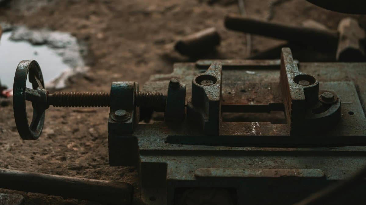 Close-up of rusty industrial tools in a workshop setting, emphasizing craftsmanship.