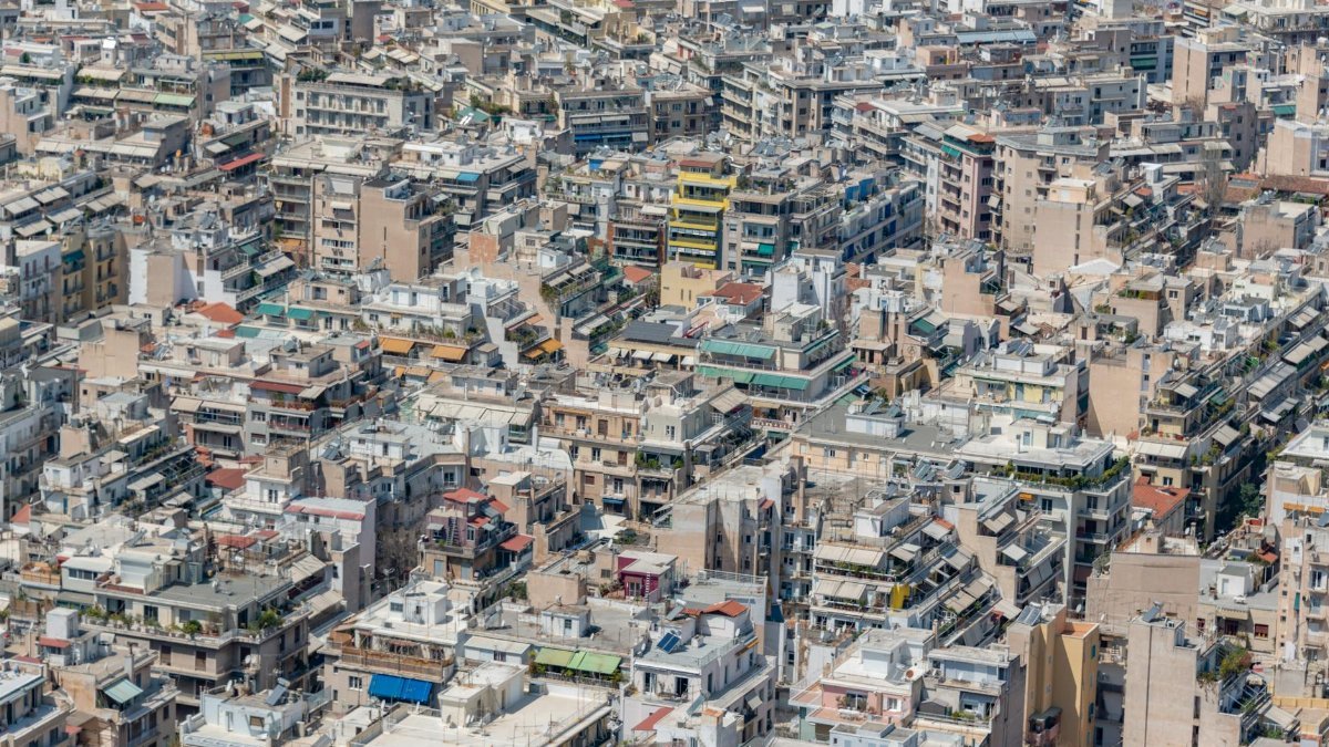 Aerial view of dense urban residential buildings in a vibrant cityscape.