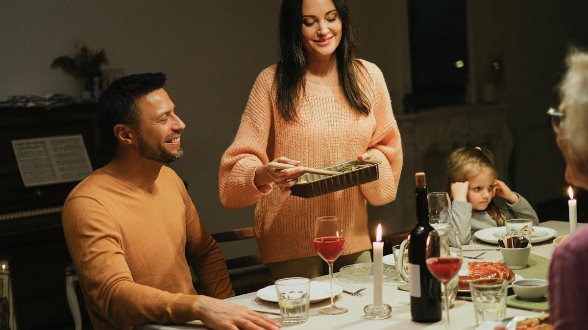 Warm family dinner with candles and wine, perfect for intimate home gatherings.